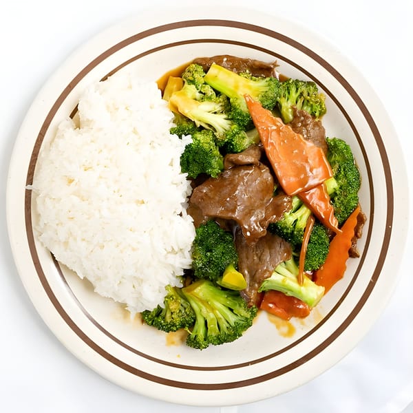 Mandarin Cafe's beef and broccoli with carrots and white rice on a white plate.